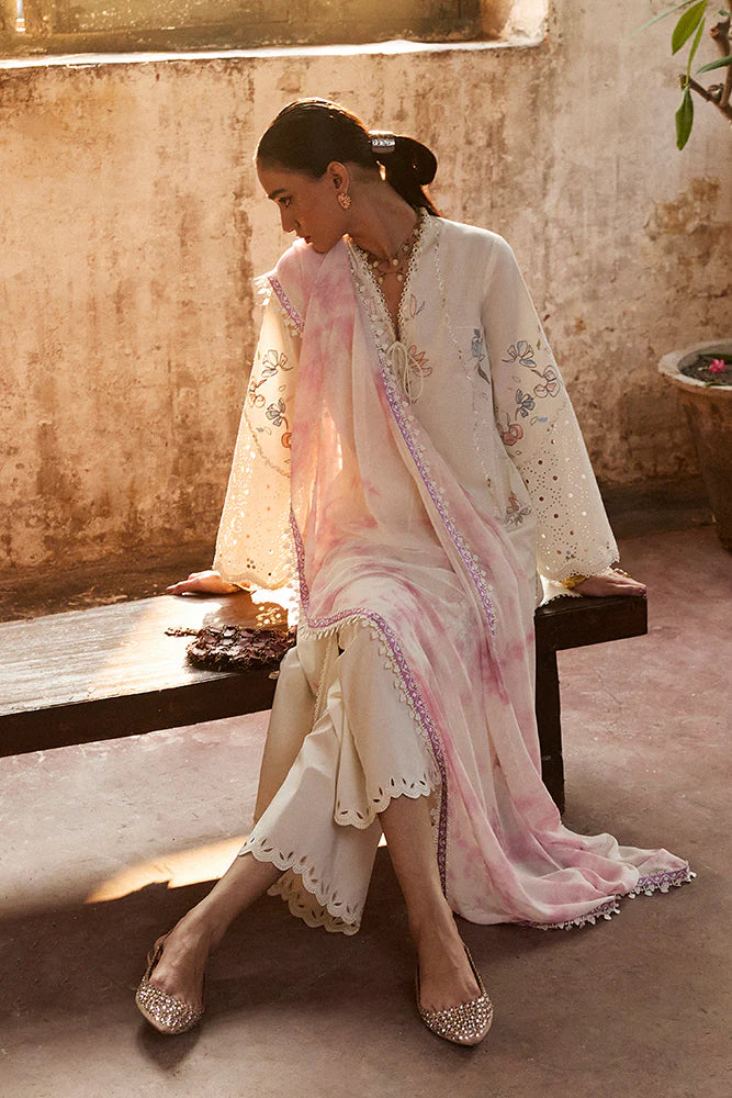 Model wearing Zeyra by Suffuse in ivory with pastel floral embroidery – graceful Pakistani luxury pret outfit in UK.
