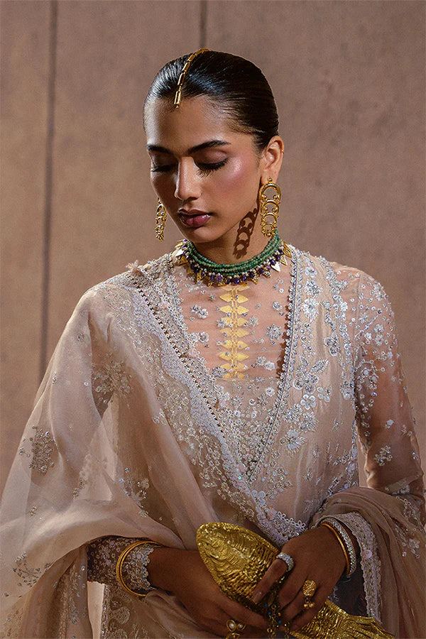 Model wearing beige embellished ensemble from Suffuse Ismira, Pakistani luxury pret, shop Pakistani clothes online in UK

