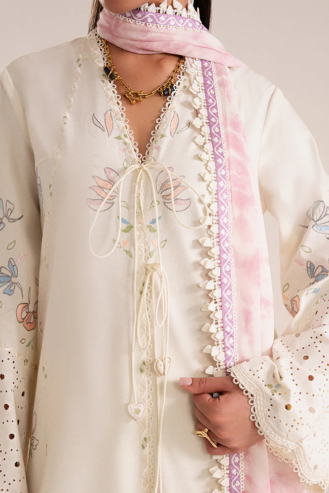Model wearing Zeyra by Suffuse in ivory with pastel floral embroidery – graceful Pakistani luxury pret outfit in UK.