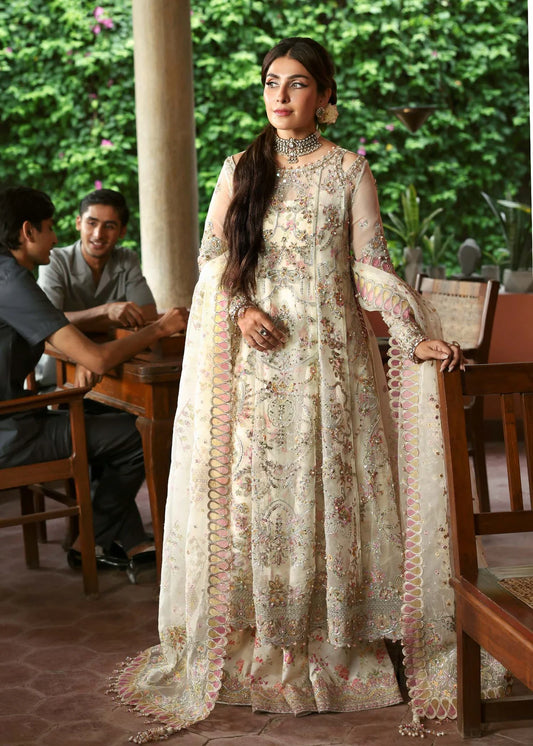 Model wearing Chanda by Kanwal Malik in ivory and pastel pink – Pakistani luxury pret outfit online in UK, ideal for festive occasions.