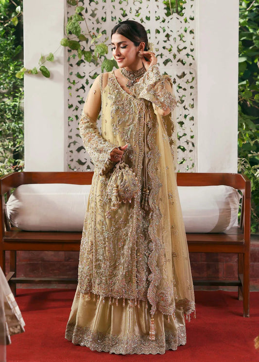 Model wearing Rukhsaar by Kanwal Malik in soft gold embroidered ensemble – Pakistani luxury pret dress available online in UK for festive wear.
