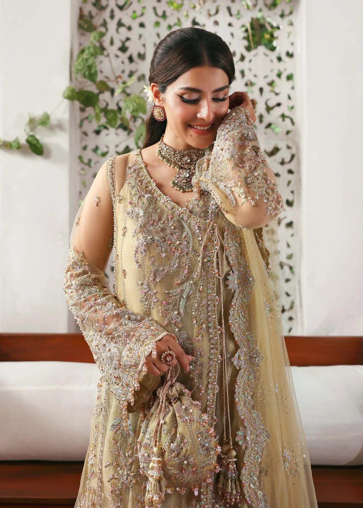 Model wearing Rukhsaar by Kanwal Malik in soft gold embroidered ensemble – Pakistani luxury pret dress available online in UK for festive wear.

