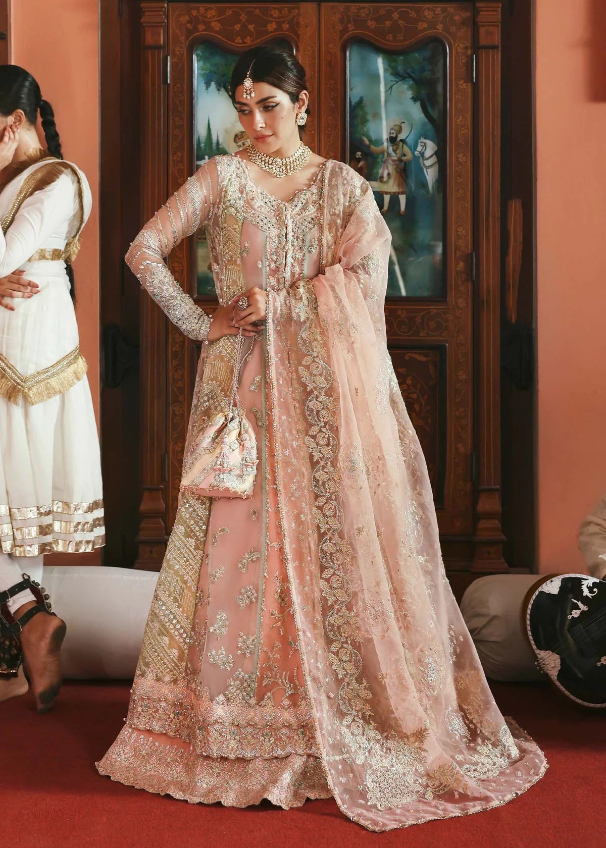 Model wearing Mehar by Kanwal Malik in soft peach pink embroidered ensemble – Pakistani luxury pret dress available online in UK for festive wear.
