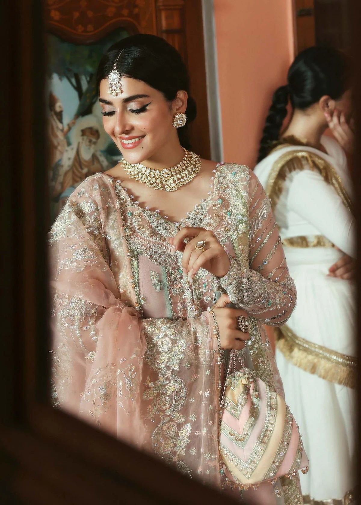 Model wearing Mehar by Kanwal Malik in soft peach pink embroidered ensemble – Pakistani luxury pret dress available online in UK for festive wear.
