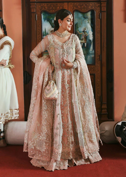 Model wearing Mehar by Kanwal Malik in soft peach pink embroidered ensemble – Pakistani luxury pret dress available online in UK for festive wear.
