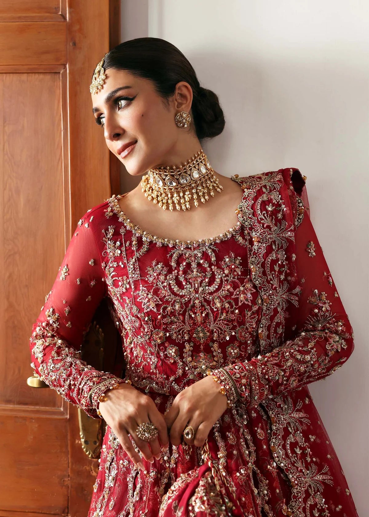 Model wearing Gulrukh by Kanwal Malik in deep red bridal ensemble with heavy embroidery – Pakistani luxury pret available online in UK.
