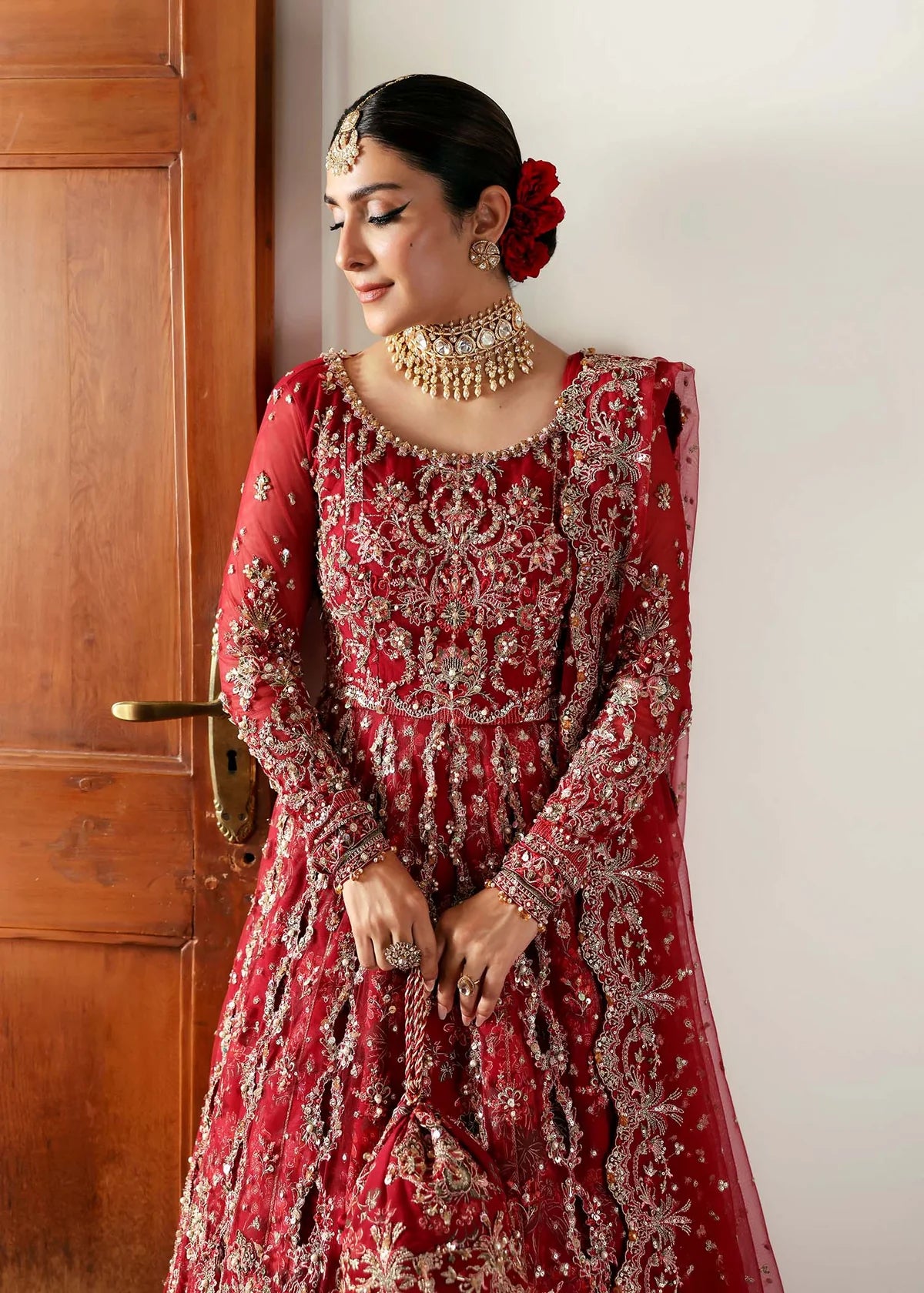 Model wearing Gulrukh by Kanwal Malik in deep red bridal ensemble with heavy embroidery – Pakistani luxury pret available online in UK.
