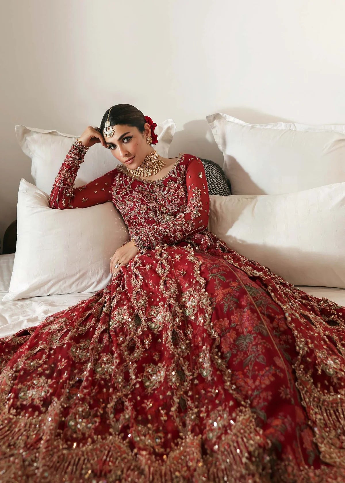 Model wearing Gulrukh by Kanwal Malik in deep red bridal ensemble with heavy embroidery – Pakistani luxury pret available online in UK.
