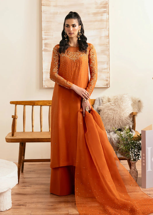 Model wearing Kanwal Malik Celina orange luxury pret dress. Shop Pakistani clothes online in the UK for festive and casual wear.