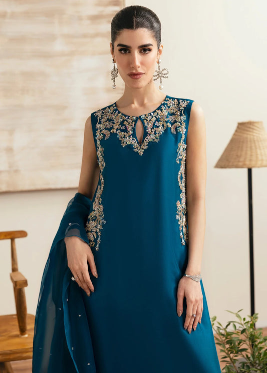 Model wearing Kanwal Malik Erina teal blue luxury pret dress. Shop Pakistani clothes online in the UK for festive and casual wear.