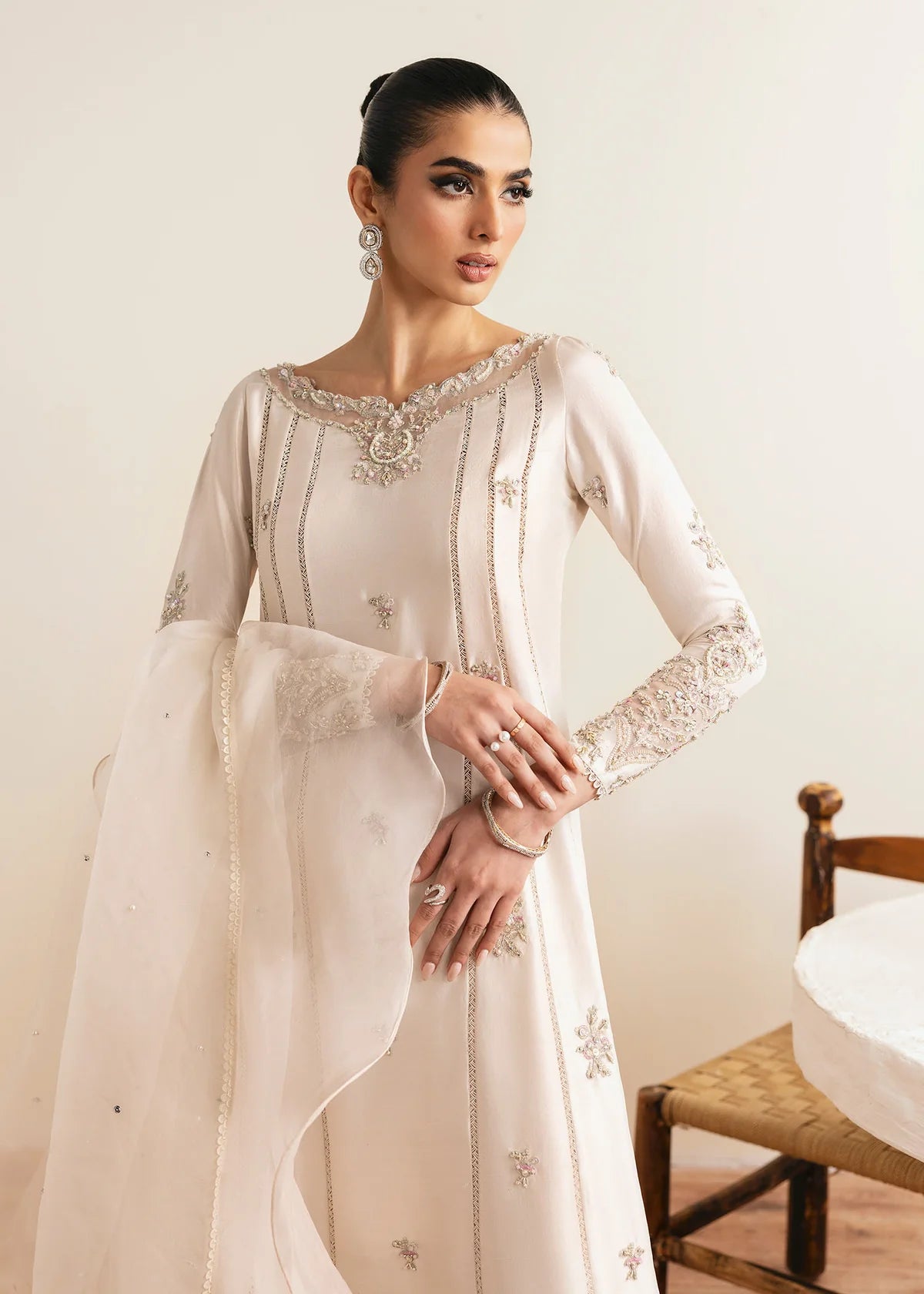 Model wearing Kanwal Malik Freya ivory embroidered luxury pret dress. Shop Pakistani clothes online in the UK for elegant occasion wear.
