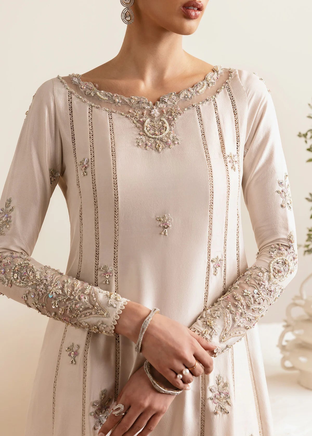 Model wearing Kanwal Malik Freya ivory embroidered luxury pret dress. Shop Pakistani clothes online in the UK for elegant occasion wear.
