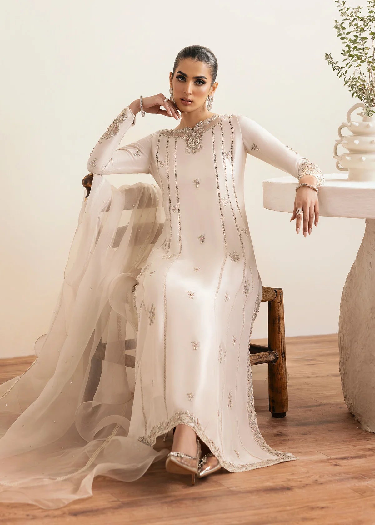 Model wearing Kanwal Malik Freya ivory embroidered luxury pret dress. Shop Pakistani clothes online in the UK for elegant occasion wear.
