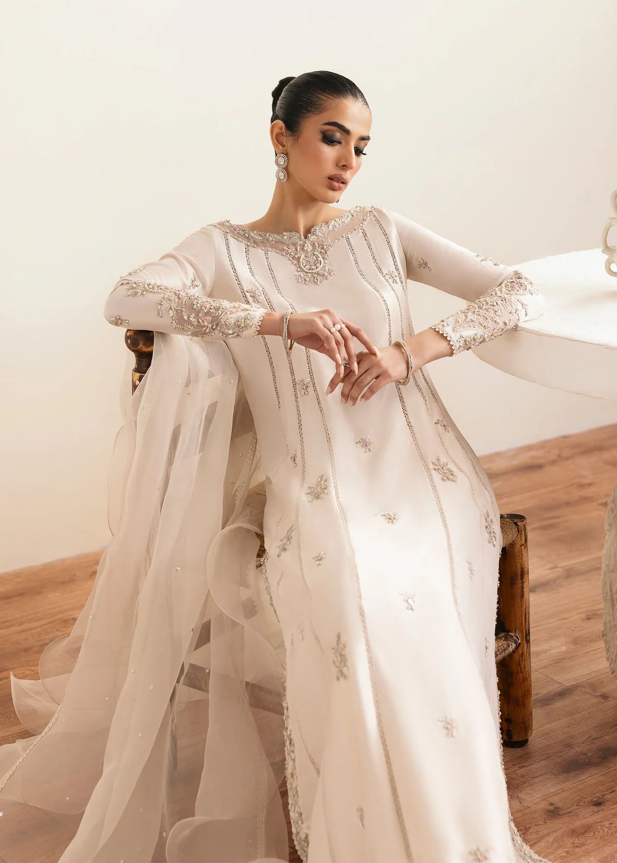 Model wearing Kanwal Malik Freya ivory embroidered luxury pret dress. Shop Pakistani clothes online in the UK for elegant occasion wear.
