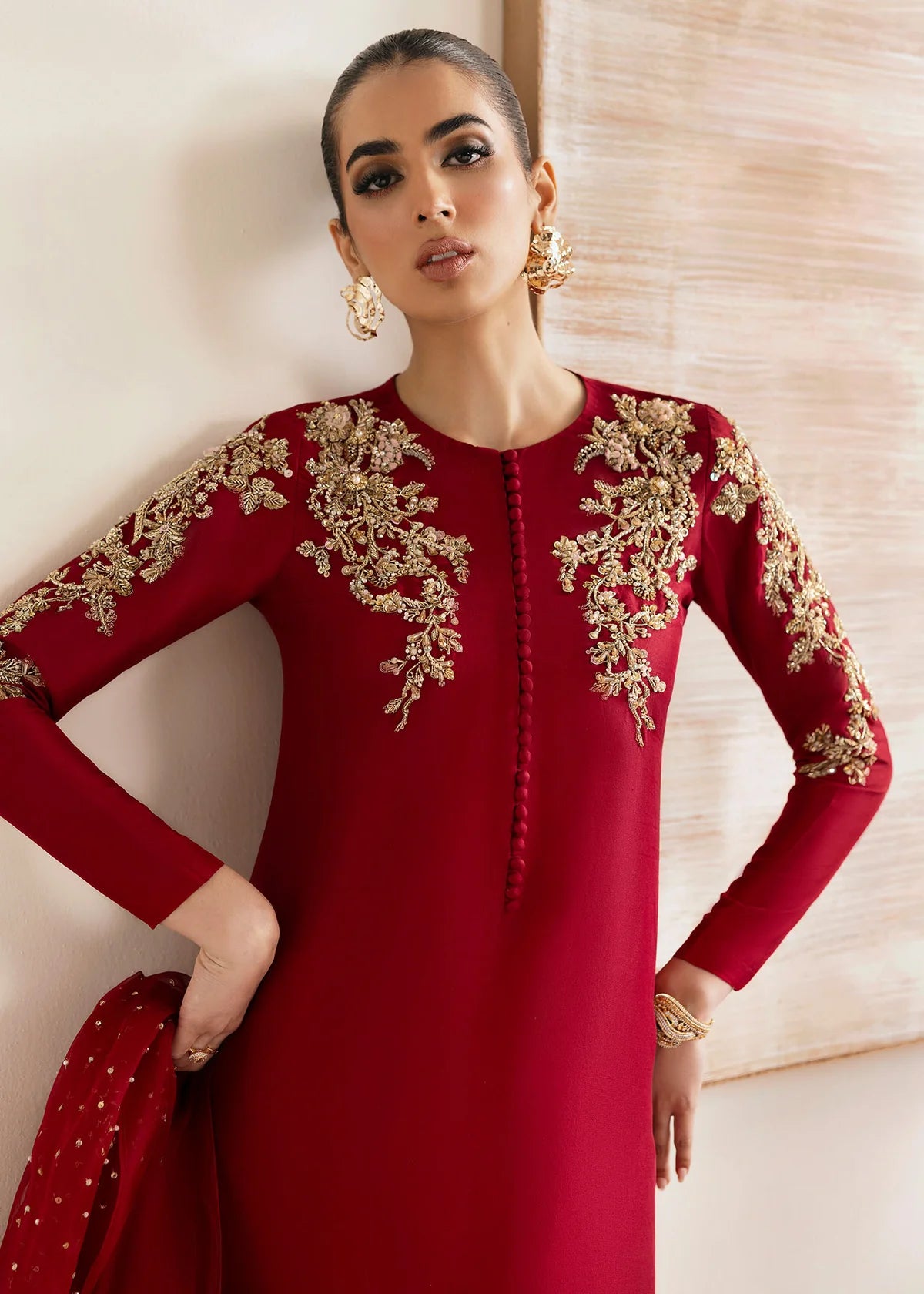 Model wearing Kanwal Malik Rosina deep red embroidered luxury pret dress. Shop Pakistani clothes online in the UK for elegant occasion wear.