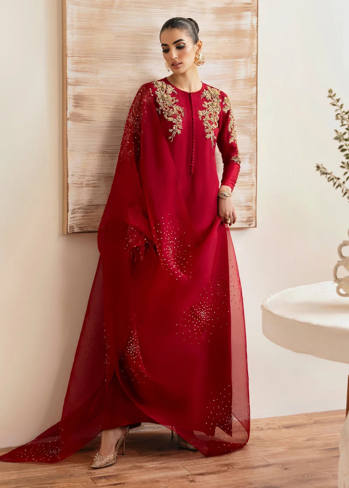 Model wearing Kanwal Malik Rosina deep red embroidered luxury pret dress. Shop Pakistani clothes online in the UK for elegant occasion wear.