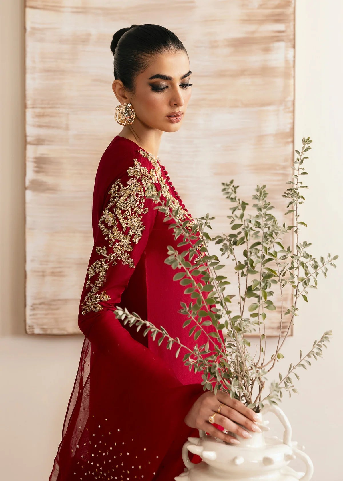 Model wearing Kanwal Malik Rosina deep red embroidered luxury pret dress. Shop Pakistani clothes online in the UK for elegant occasion wear.