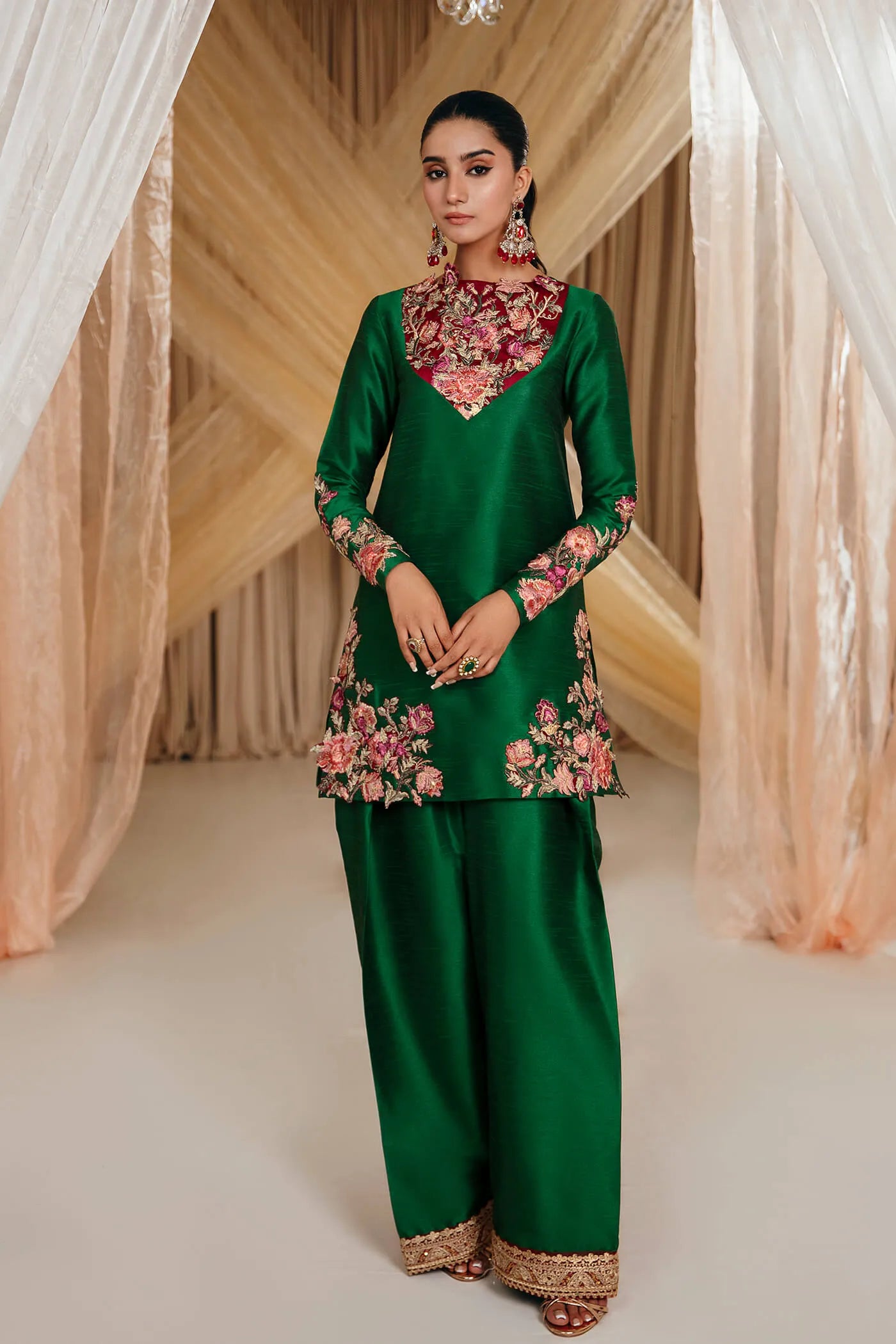 Model wearing Faiza Saqlain's Emerald Garden dress from the Musferah Saad Mystere Eid Collection '24. A stunning green Pakistani Eid dress adorned with rich embroidery, perfect for those seeking Pakistani designer clothes in the UK.