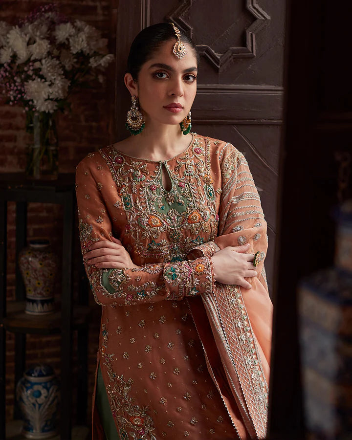 model wearing rust and green embroidered dress by Faiza Saqlain, Pakistani luxury pret available online in UK
