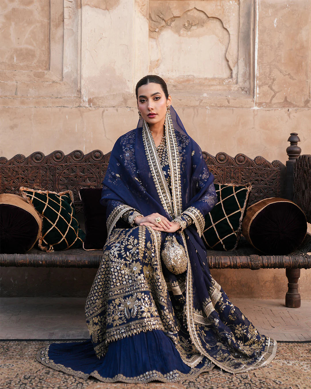 Model wearing navy blue Faiza Saqlain Ayska outfit with intricate gold embroidery, ideal for Pakistani luxury pret and festive wear in UK.