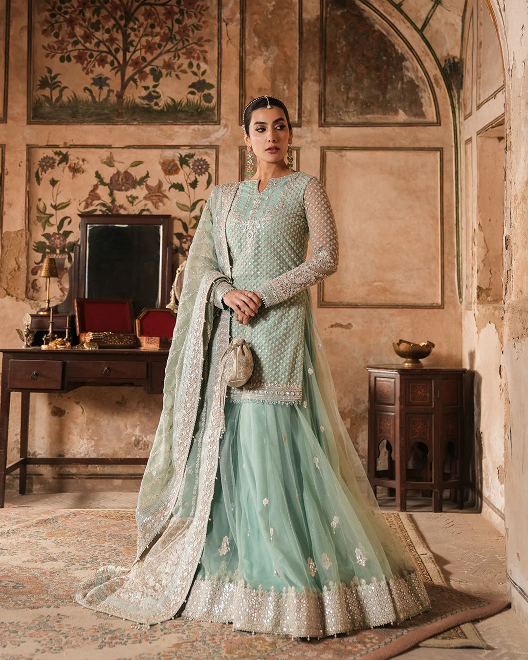 Model wearing mint green Faiza Saqlain Valari outfit with embellished net dupatta and lehenga, perfect for Pakistani luxury pret in UK.