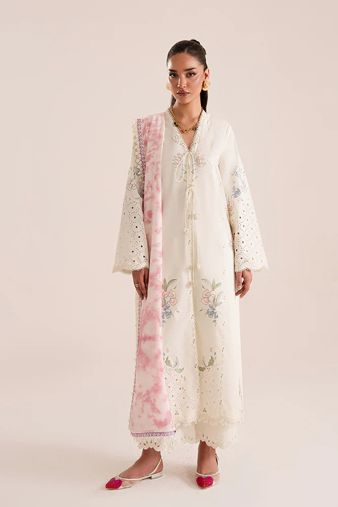 Model wearing Zeyra by Suffuse in ivory with pastel floral embroidery – graceful Pakistani luxury pret outfit in UK.