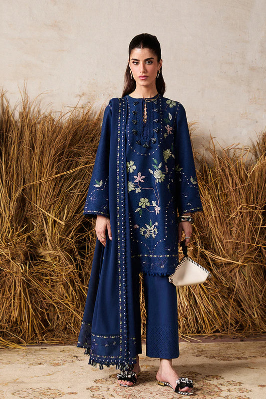 Model wearing Lazeh by Suffuse in deep navy blue with floral embroidery – elegant Pakistani luxury pret outfit in UK.