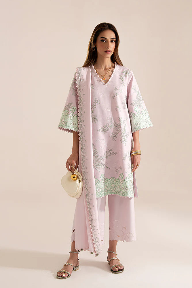 Model wearing Sarin by Suffuse in pastel pink with green embroidery – feminine Pakistani luxury pret outfit in UK.