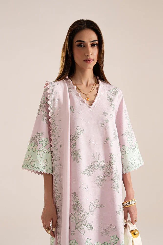 Model wearing Sarin by Suffuse in pastel pink with green embroidery – feminine Pakistani luxury pret outfit in UK.