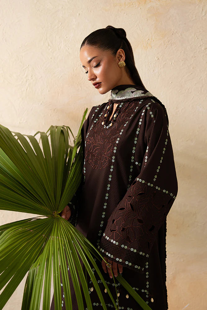 Model wearing Ruva by Suffuse in deep chocolate brown with embroidered details – chic Pakistani luxury pret outfit in UK.