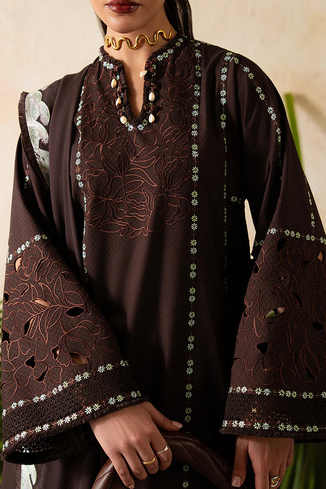 Model wearing Ruva by Suffuse in deep chocolate brown with embroidered details – chic Pakistani luxury pret outfit in UK.