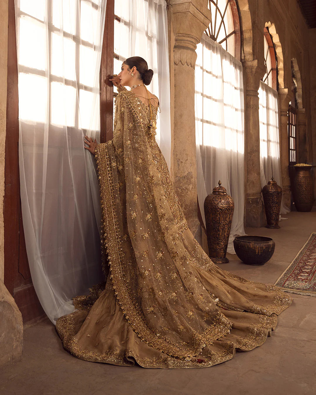 Model wearing golden brown bridal dress Naisha by Faiza Saqlain, Pakistani luxury pret online in UK for weddings.