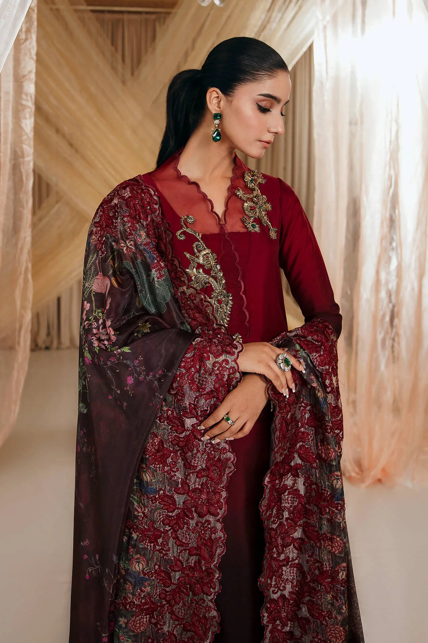 Model wearing Faiza Saqlain's Crimson Rose dress from the Musferah Saad Mystere Eid Collection '24. A striking maroon Pakistani Eid dress with gold embroidery and a beautifully detailed dupatta, ideal for Pakistani designer clothes shoppers in the UK.