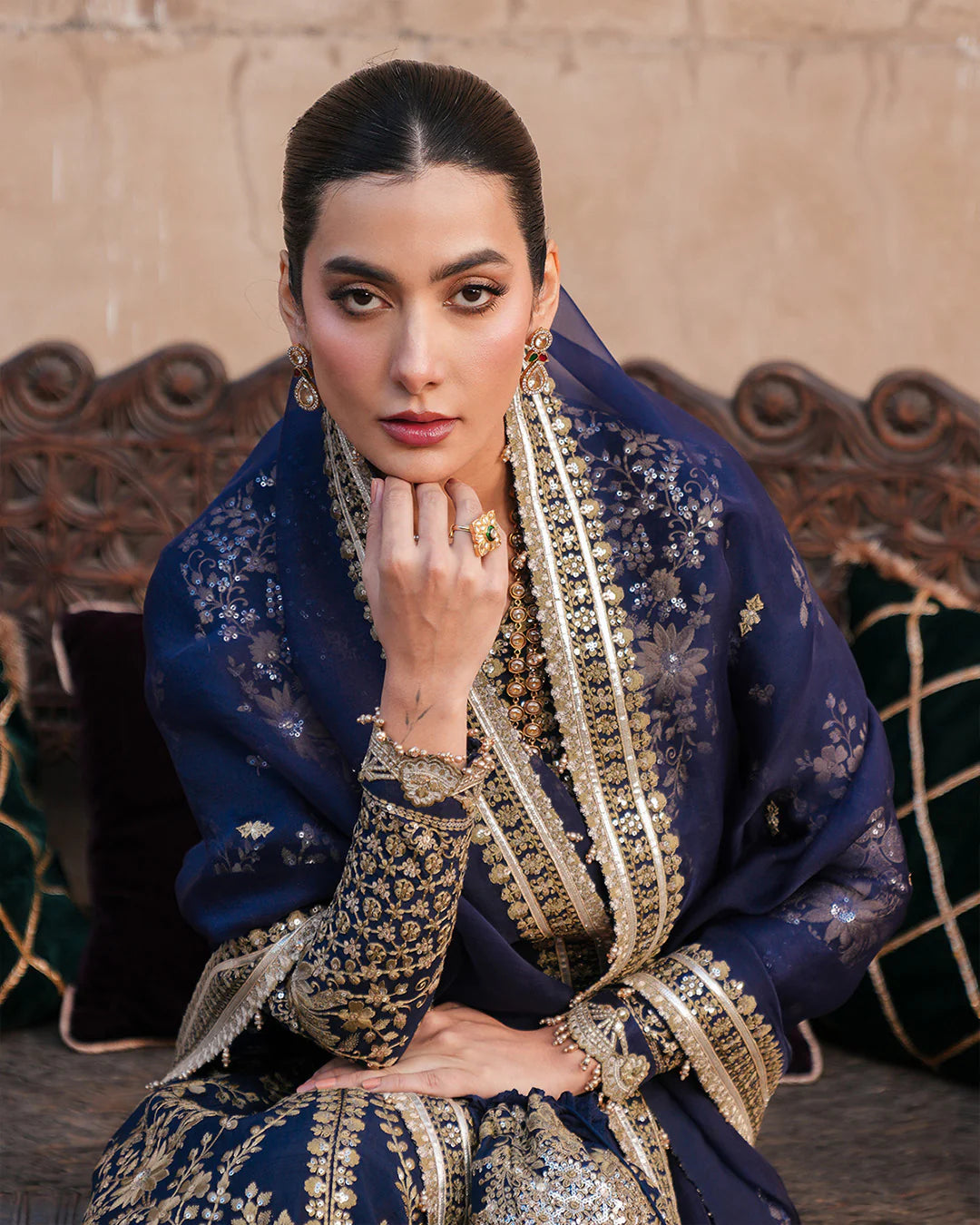 Model wearing navy blue Faiza Saqlain Ayska outfit with intricate gold embroidery, ideal for Pakistani luxury pret and festive wear in UK.