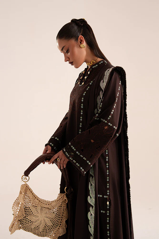 Model wearing Ruva by Suffuse in deep chocolate brown with embroidered details – chic Pakistani luxury pret outfit in UK.