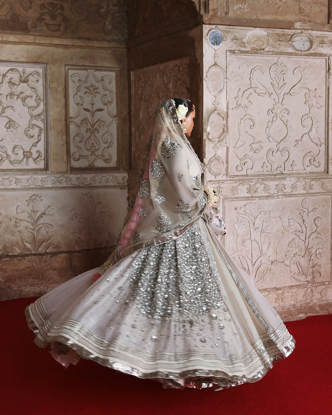 Model wearing Mina by Hussain Rehar in ivory with silver embellishments and cape – luxurious Pakistani luxury pret outfit in UK.