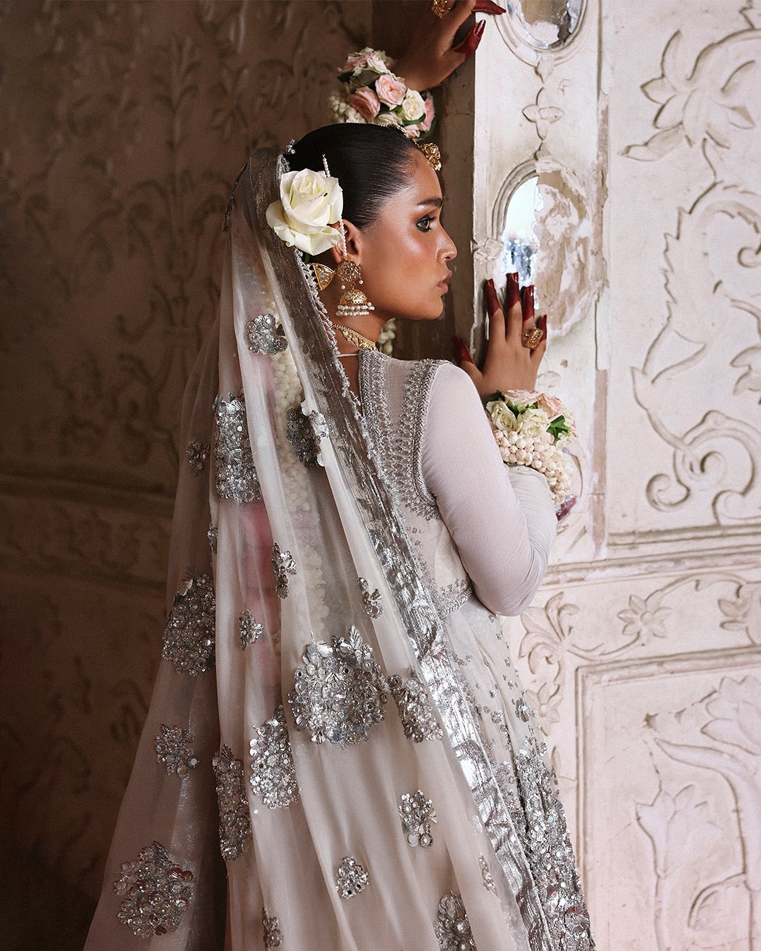 Model wearing Mina by Hussain Rehar in ivory with silver embellishments and cape – luxurious Pakistani luxury pret outfit in UK.