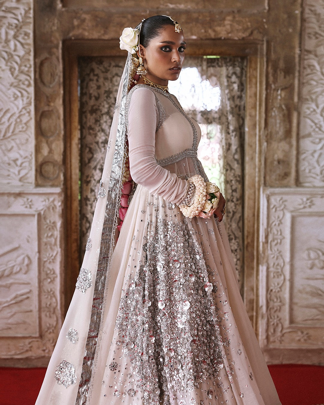 Model wearing Mina by Hussain Rehar in ivory with silver embellishments and cape – luxurious Pakistani luxury pret outfit in UK.