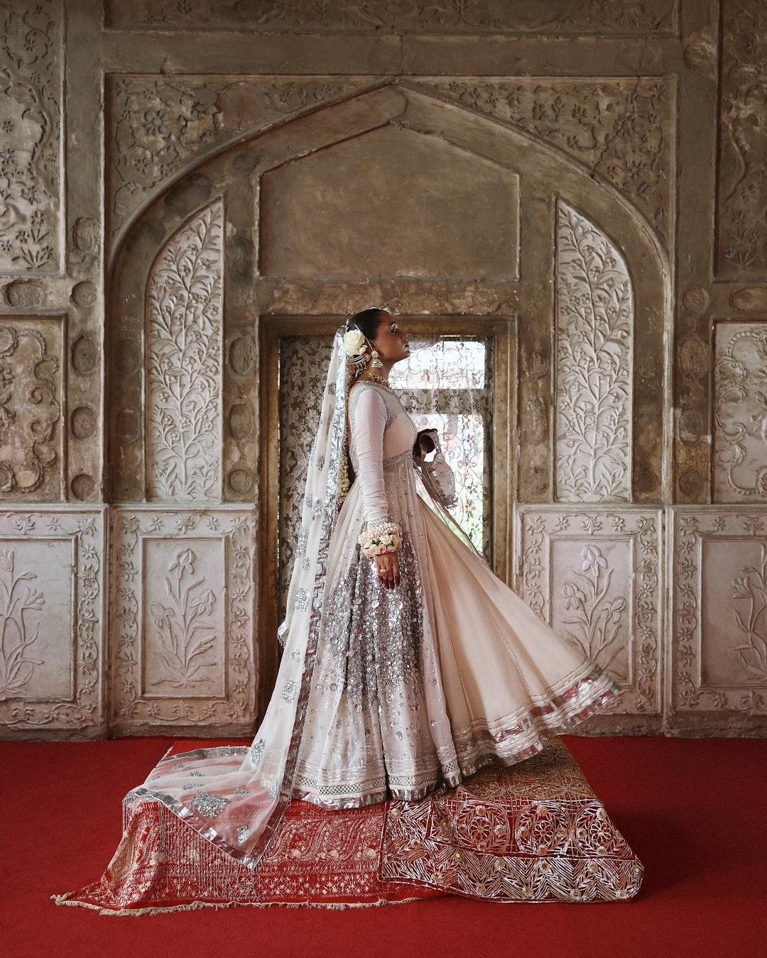 Model wearing Mina by Hussain Rehar in ivory with silver embellishments and cape – luxurious Pakistani luxury pret outfit in UK.