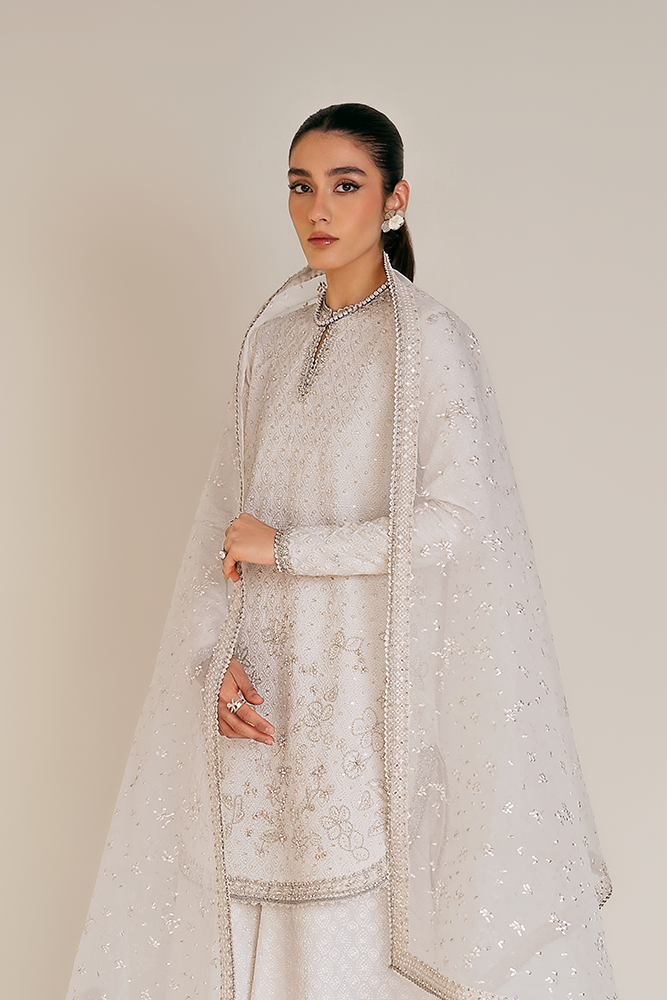 Model wearing ELUNA, three-quarter view, a Pakistani designer outfit by Suffuse, available online in the UK.