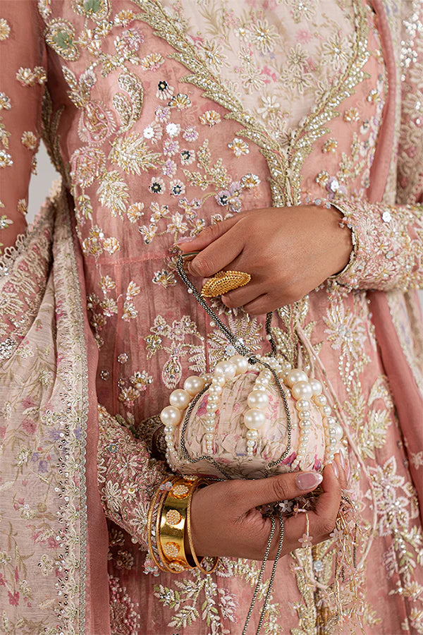 Model wearing rose coral embellished ensemble from Suffuse Novara, Pakistani luxury pret, shop Pakistani clothes online in UK
