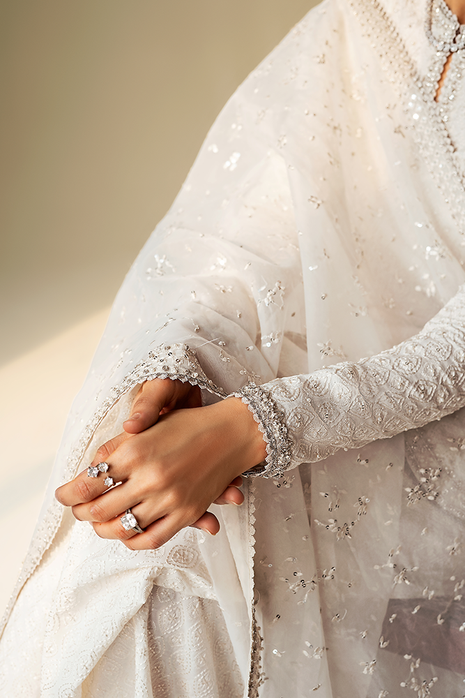 Model wearing ELUNA, embroidery focus, a Pakistani designer outfit by Suffuse, available online in the UK.