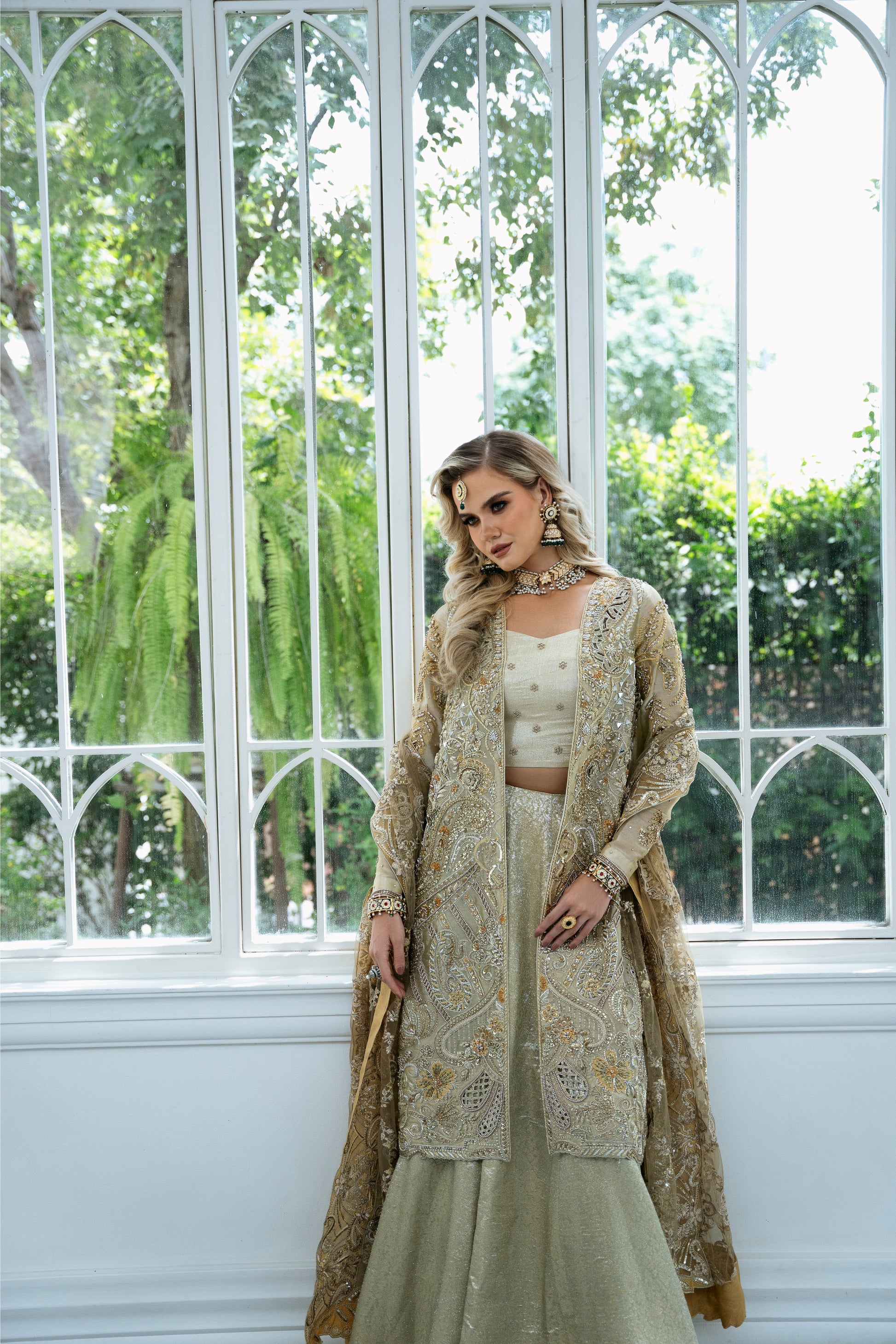 Model wearing Marigold from Mysie by Tahira, a golden-hued ensemble with intricate embroidery, ideal for Pakistani luxury pret in the UK.