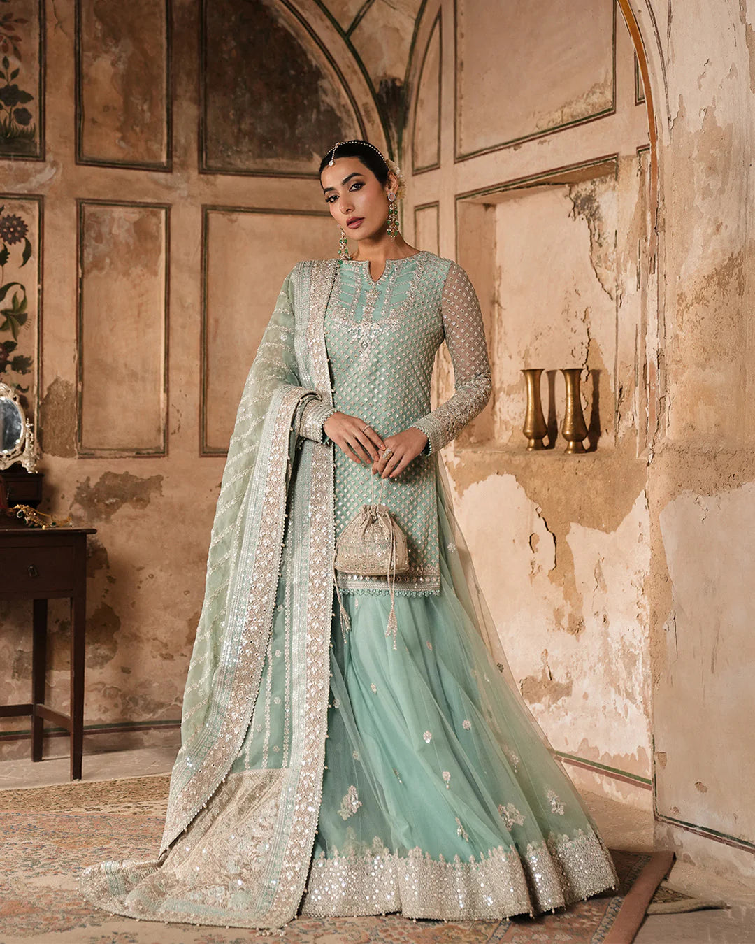 Model wearing mint green Faiza Saqlain Valari outfit with embellished net dupatta and lehenga, perfect for Pakistani luxury pret in UK.