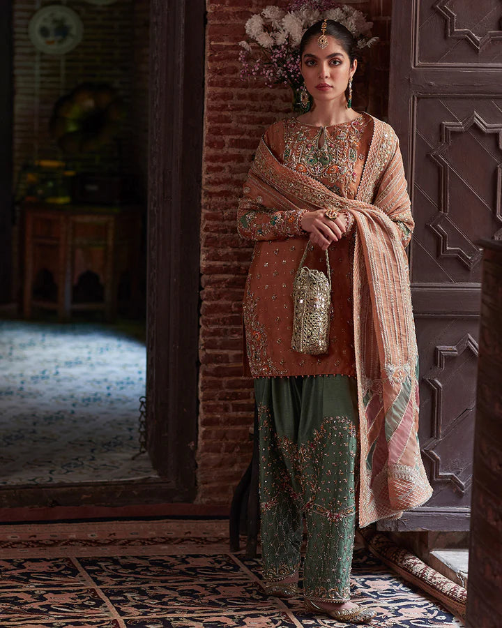model wearing rust and green embroidered dress by Faiza Saqlain, Pakistani luxury pret available online in UK