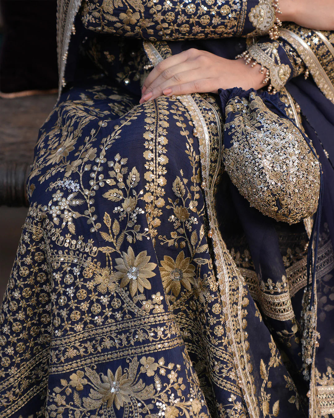 Model wearing navy blue Faiza Saqlain Ayska outfit with intricate gold embroidery, ideal for Pakistani luxury pret and festive wear in UK.