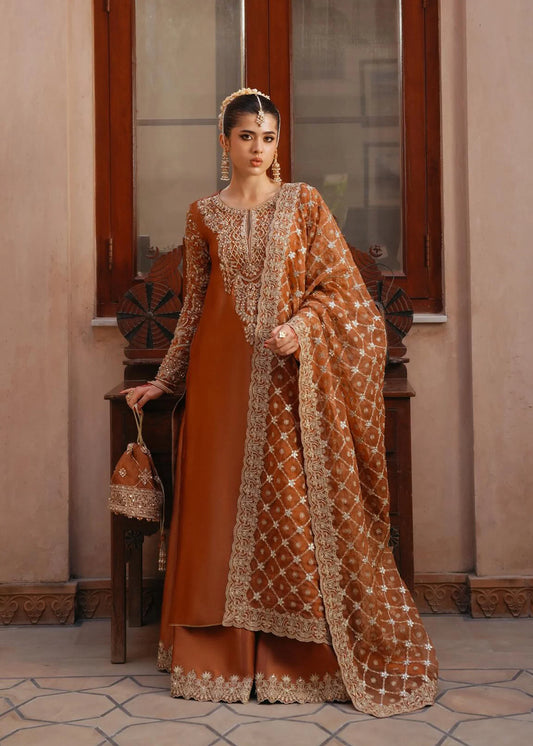 Model wearing Zulekha by Kanwal Malik in rust orange with gold embroidery – timeless Pakistani luxury pret available online in UK.