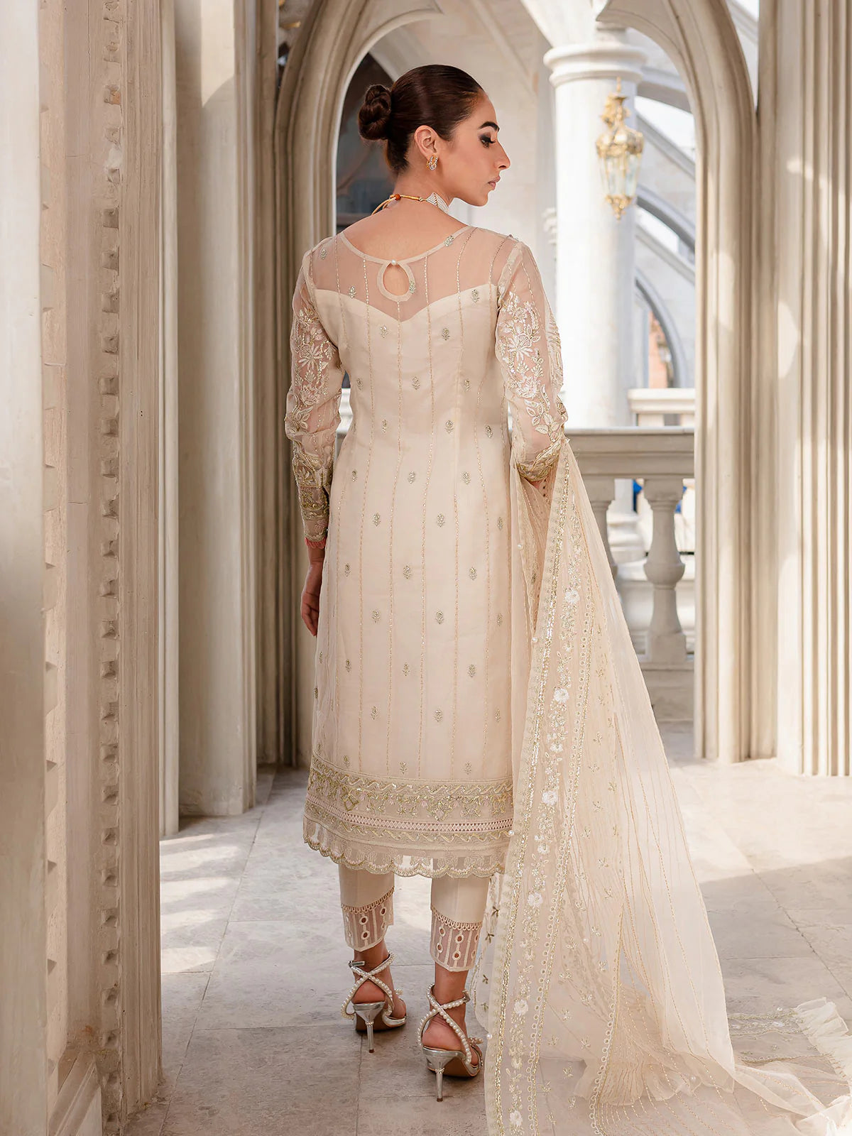 Model wearing ivory Yaram outfit from Gulaal—elegant Pakistani luxury pret, perfect for festive wear, shop Pakistani clothes online in UK.
