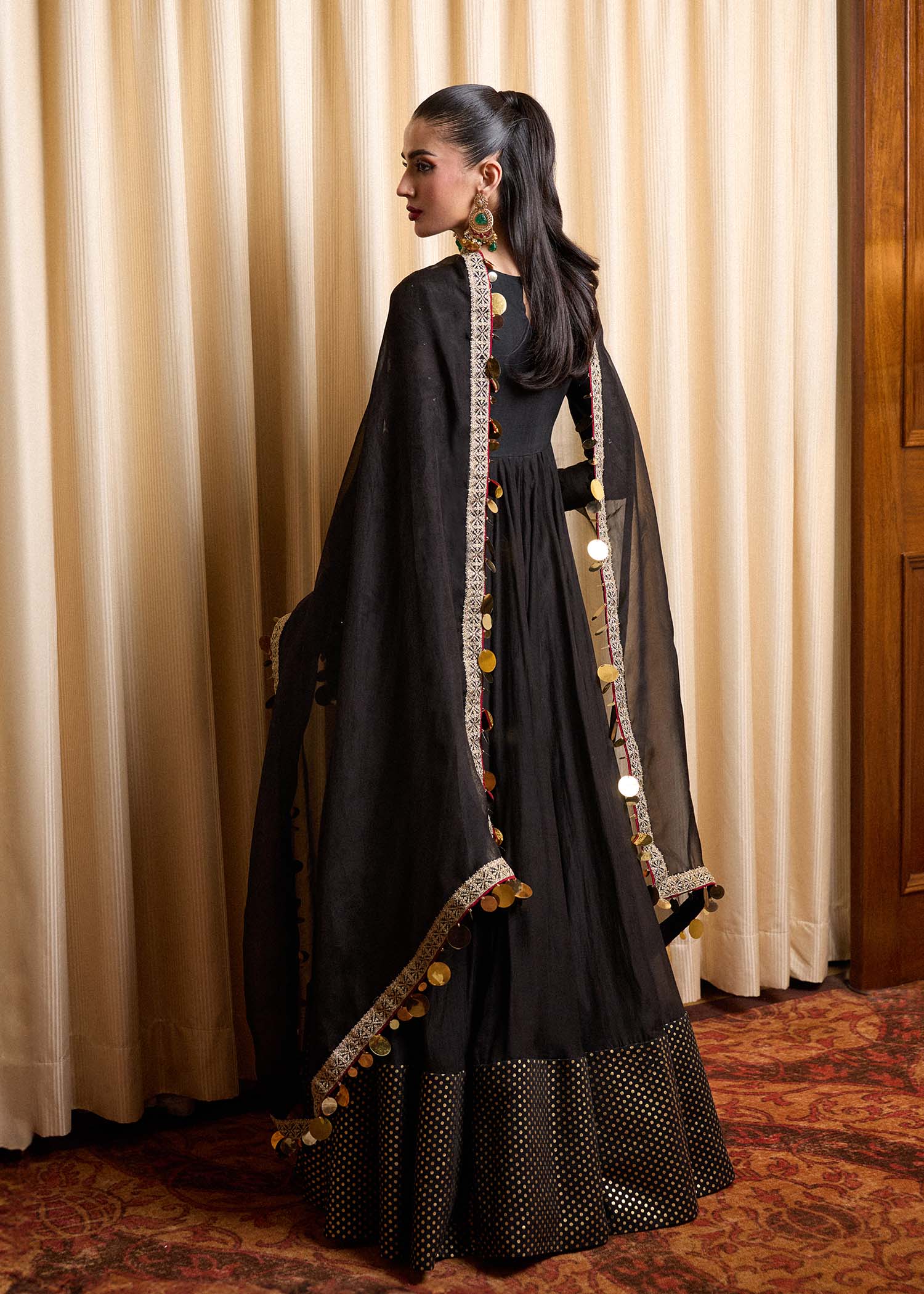 Model wearing a black Rubai dress from Hussain Rehar's Luxury Pret collection. Pakistani clothes online in UK.