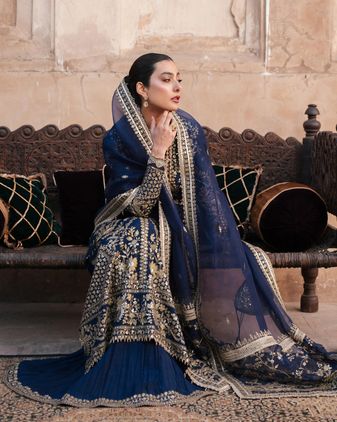 Model wearing navy blue Faiza Saqlain Ayska outfit with intricate gold embroidery, ideal for Pakistani luxury pret and festive wear in UK.